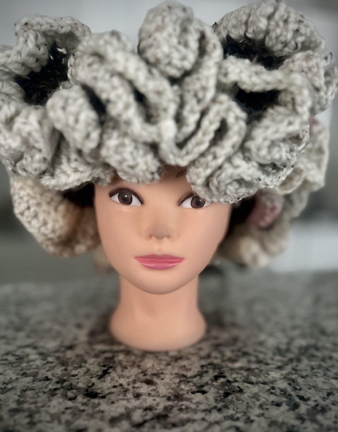 Full front view of the cream and blush ruffle hat