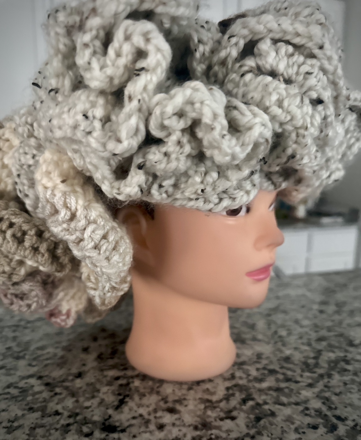 Opposite side view of the handmade cream ruffle hat