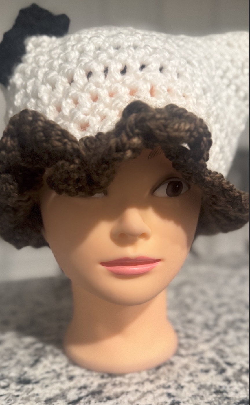 Close front view of the white and brown puppy ruffle hat